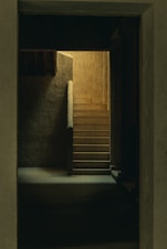 brown wooden door on gray concrete wall