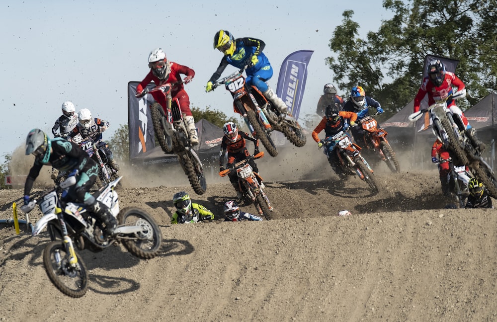 man in blue and yellow jacket riding motocross dirt bike