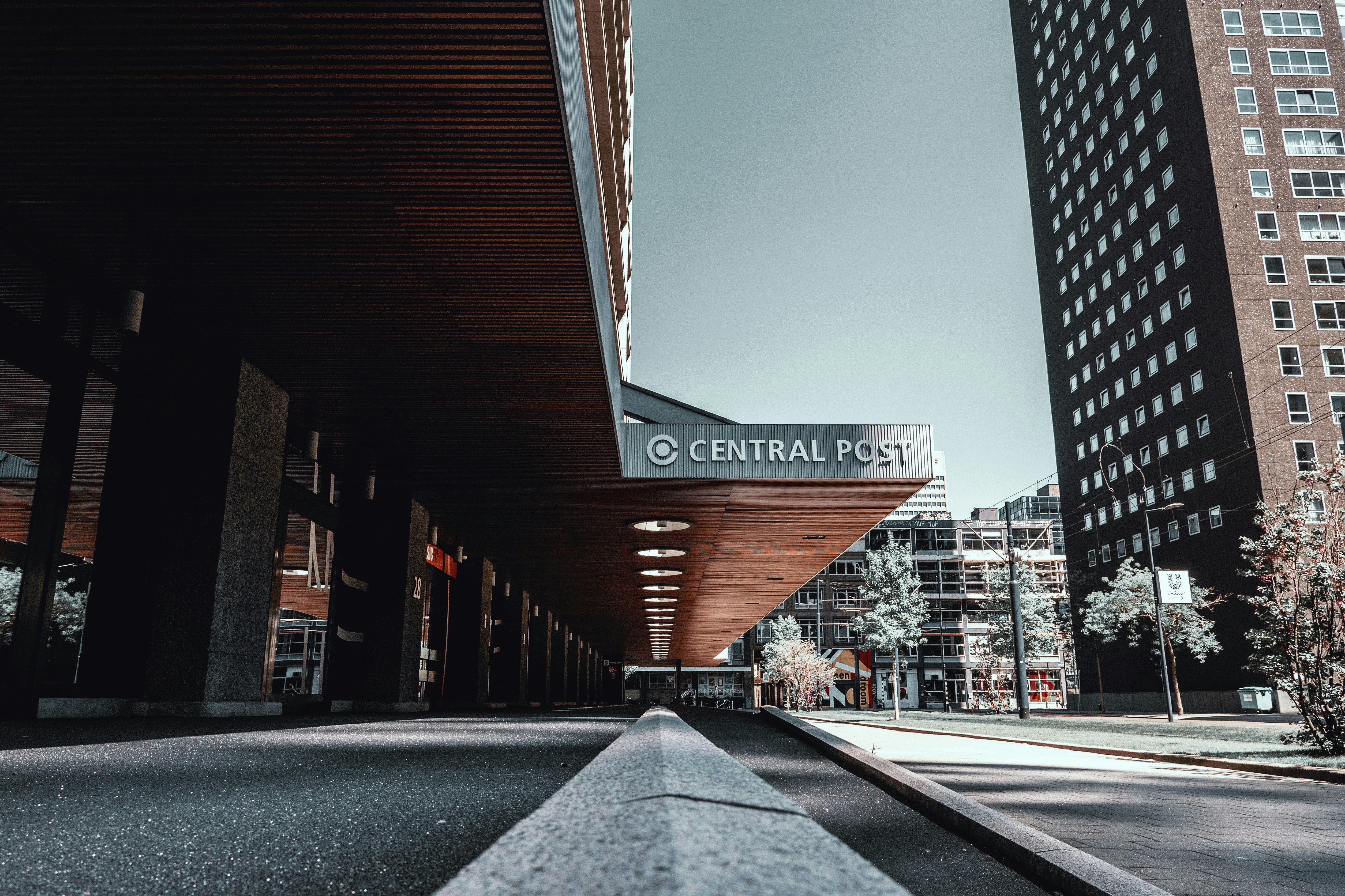 red and white concrete building during daytime, Cental Post | Rotterdam architecture
