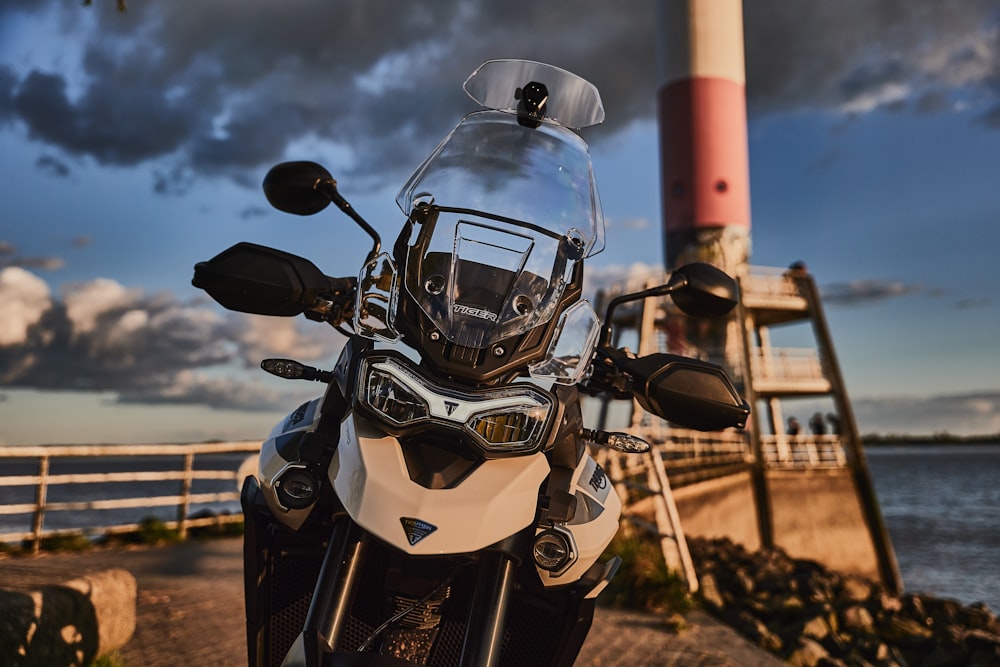 white and black motorcycle on brown ground during daytime