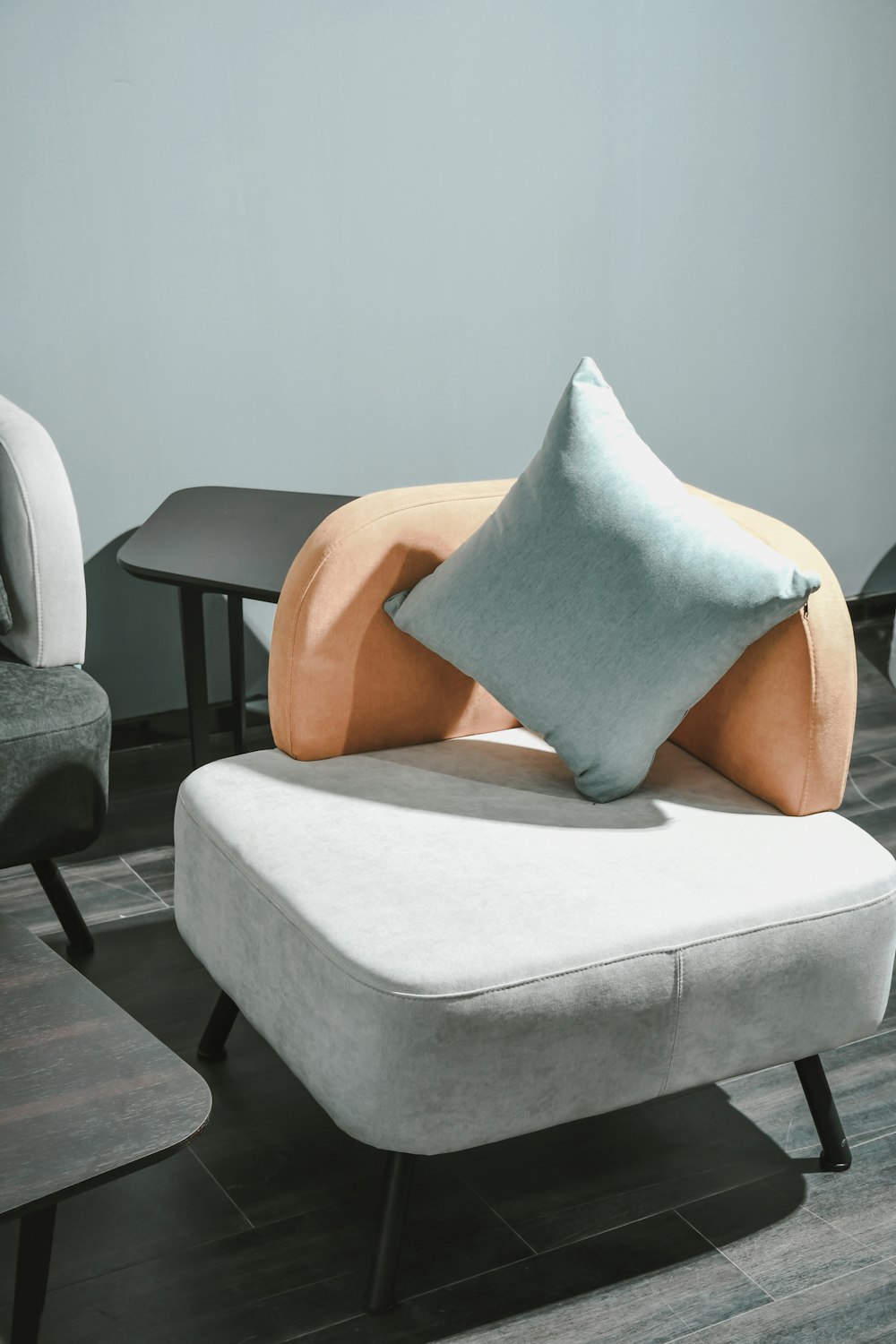 white and brown throw pillow on white sofa chair