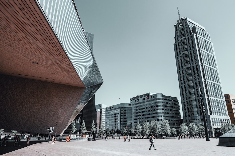 people walking on street near high rise buildings during daytime