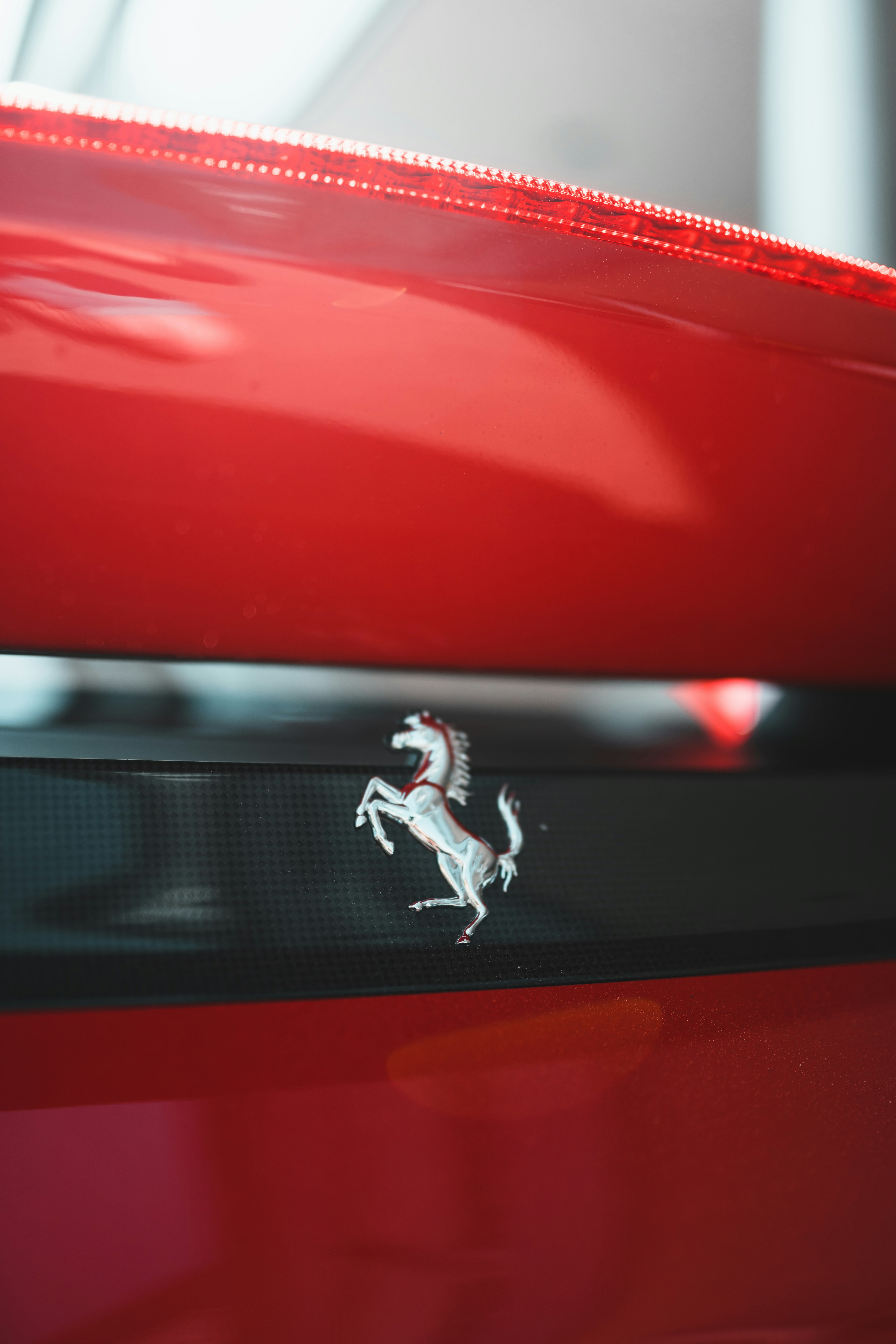 man in white shirt and pants jumping on red car