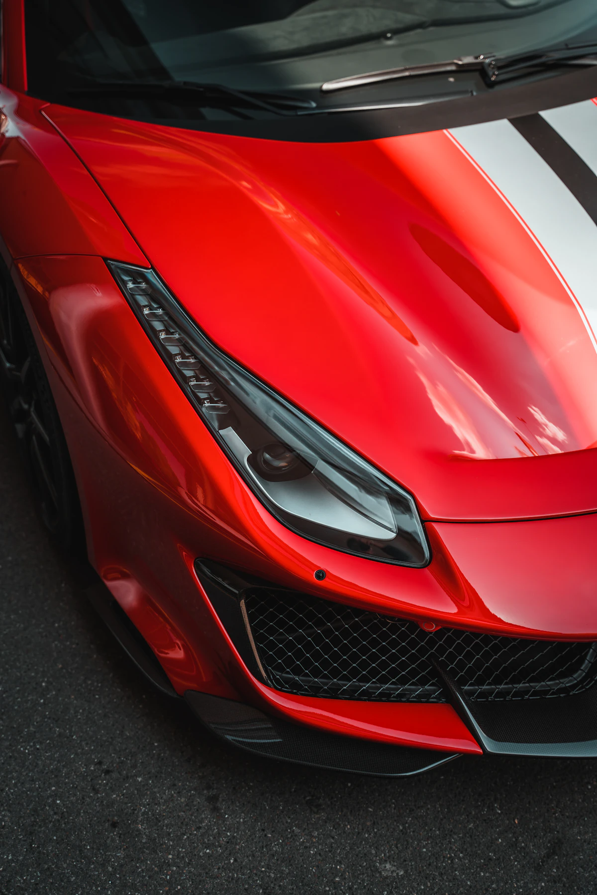 Ceramic-coated car bodywork with water-beading gloss under dark studio light