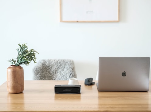 macbook pro on brown wooden table