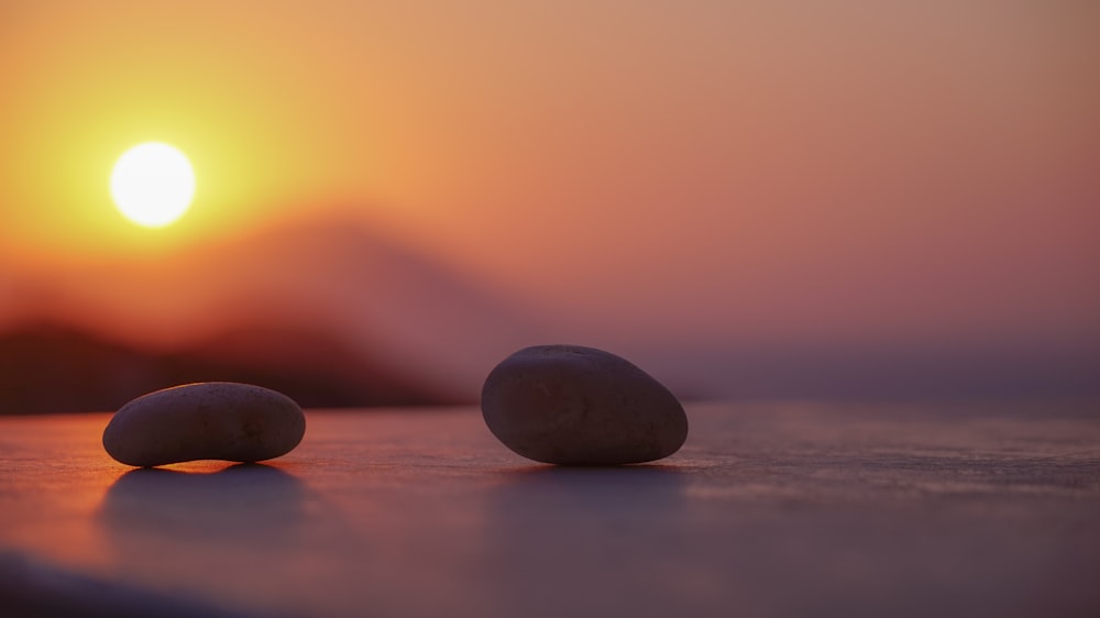 two black stones on brown wooden table