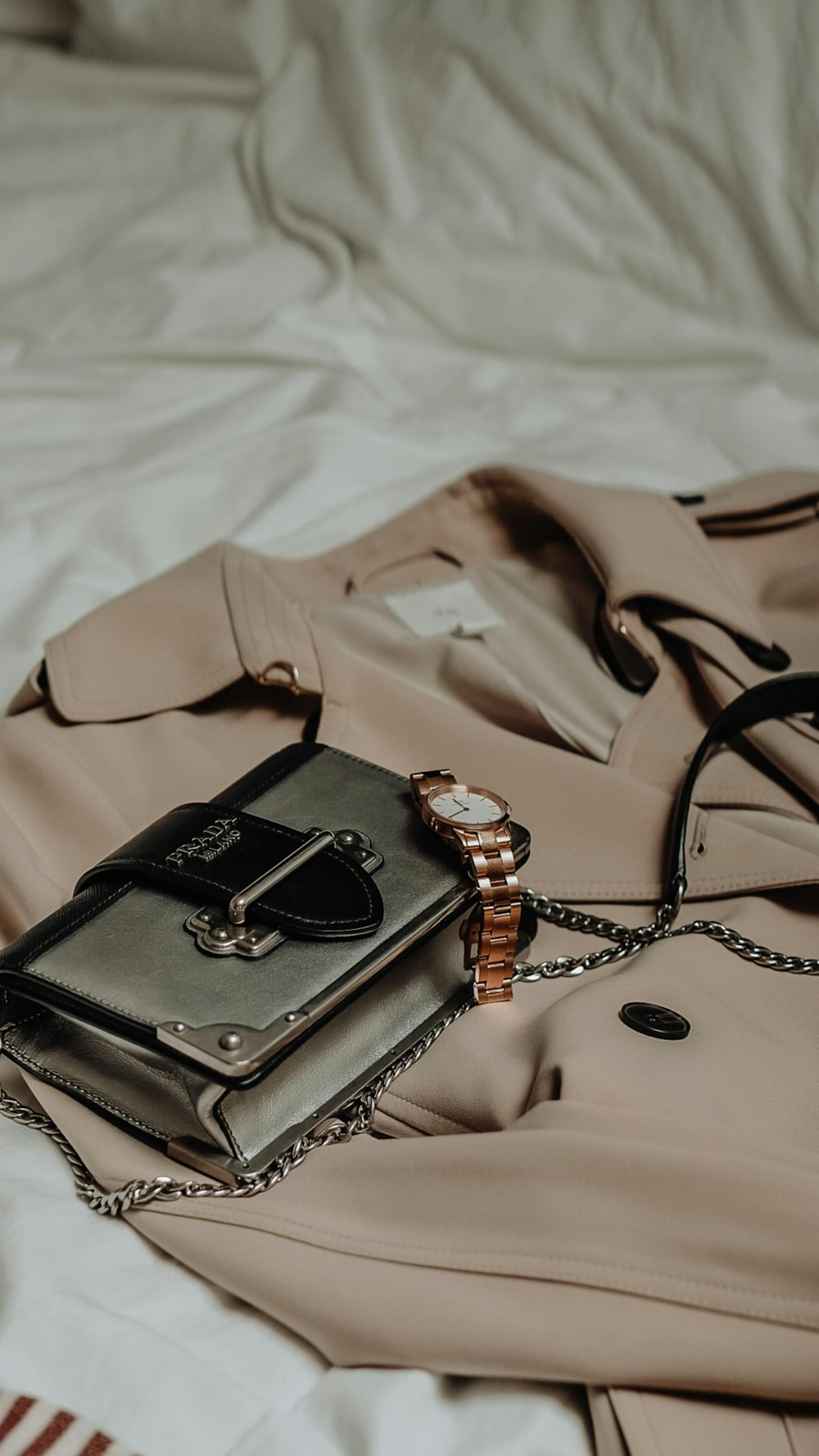 brown leather sling bag on white textile