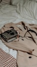 brown leather sling bag on white and red textile