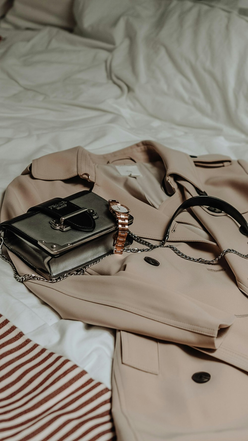 brown leather sling bag on white and red textile