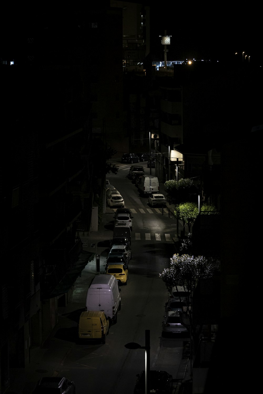 cars parked on the side of the road during night time