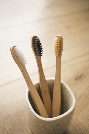 brown wooden bamboo toothbrush in gray ceramic bowl