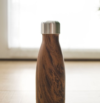 brown wooden bottle on white table