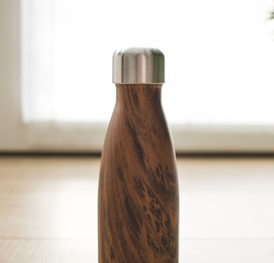 brown wooden bottle on white table