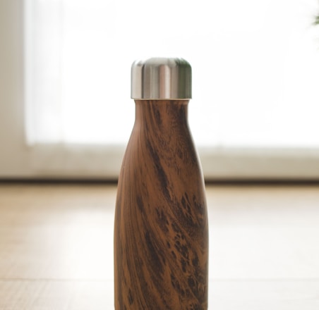 brown wooden bottle on white table