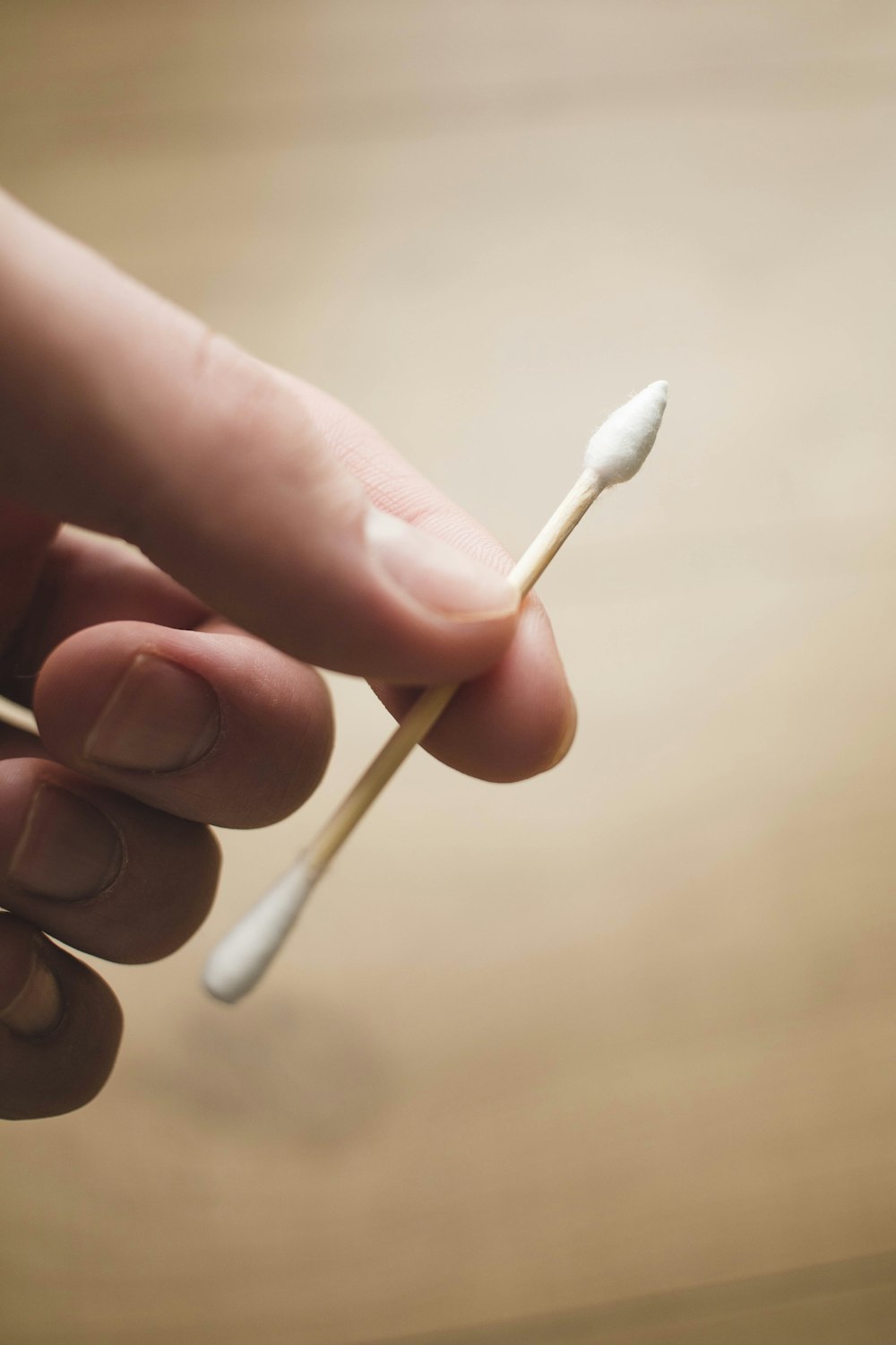 person holding white cotton buds