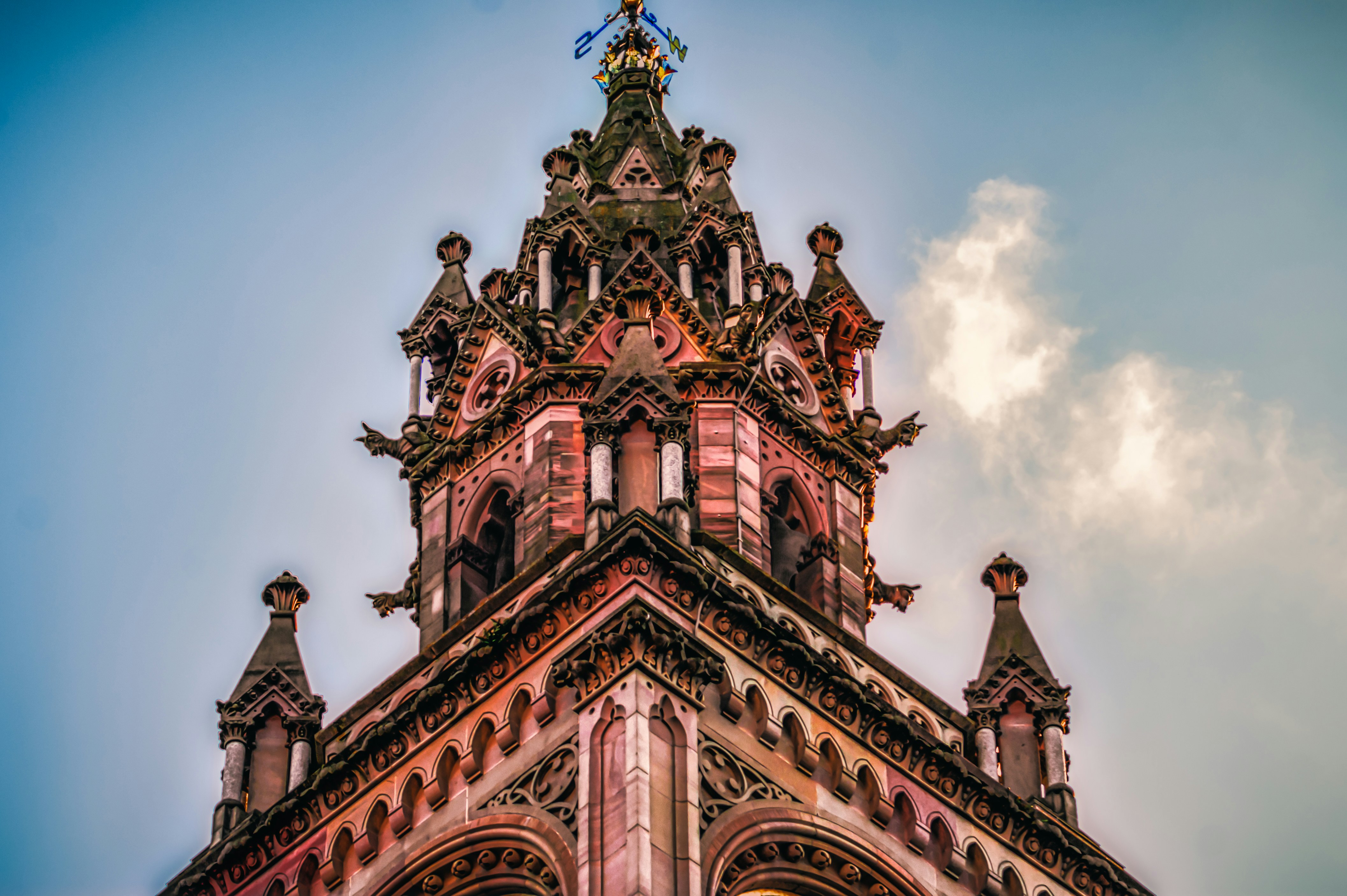 brown and black concrete building under blue sky, The gothic stylings, replete with gargoyles, of The Albert Clock near the waterfront in Belfast (Sept, 2019).