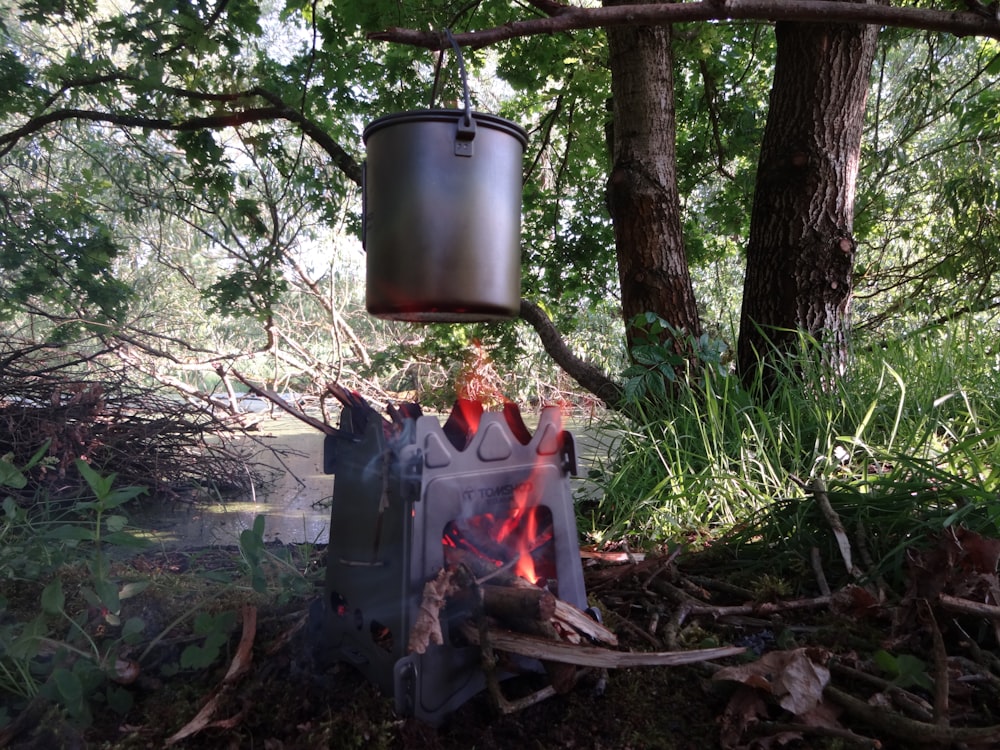 black and gray charcoal grill on forest during daytime