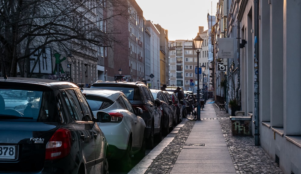 cars parked on sidewalk during daytime