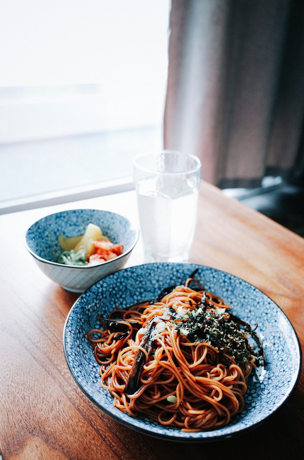 brown pasta on white ceramic bowl