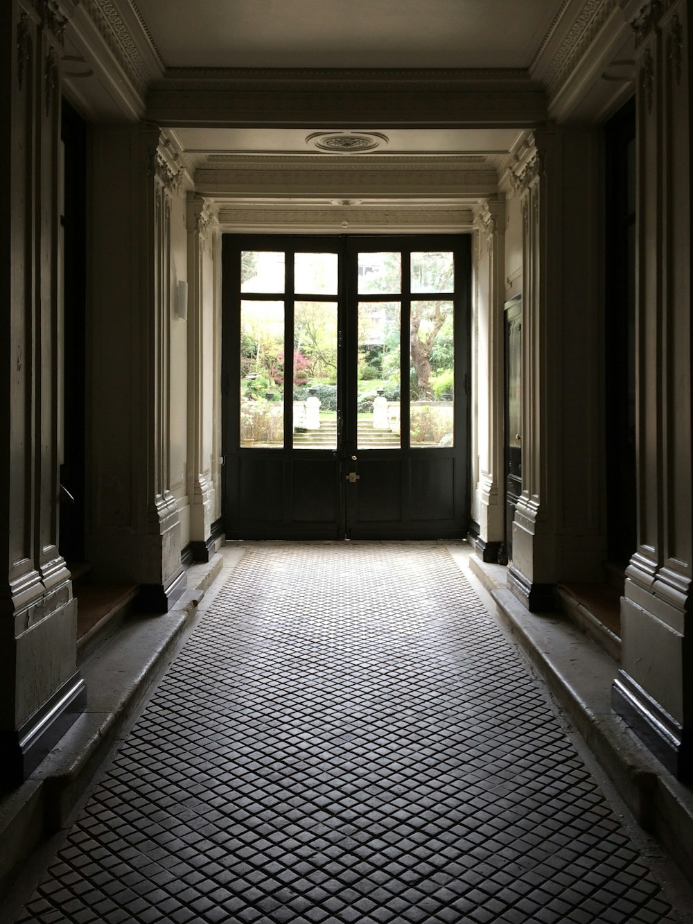 black and white hallway with white wooden framed glass window