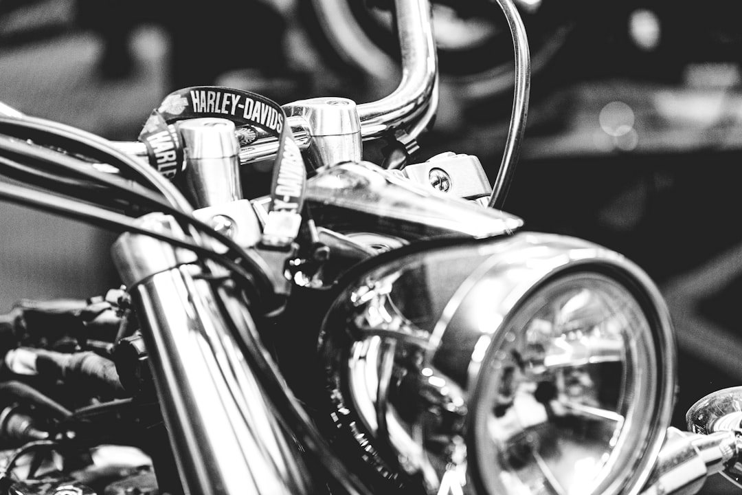 grayscale photo of motorcycle headlight