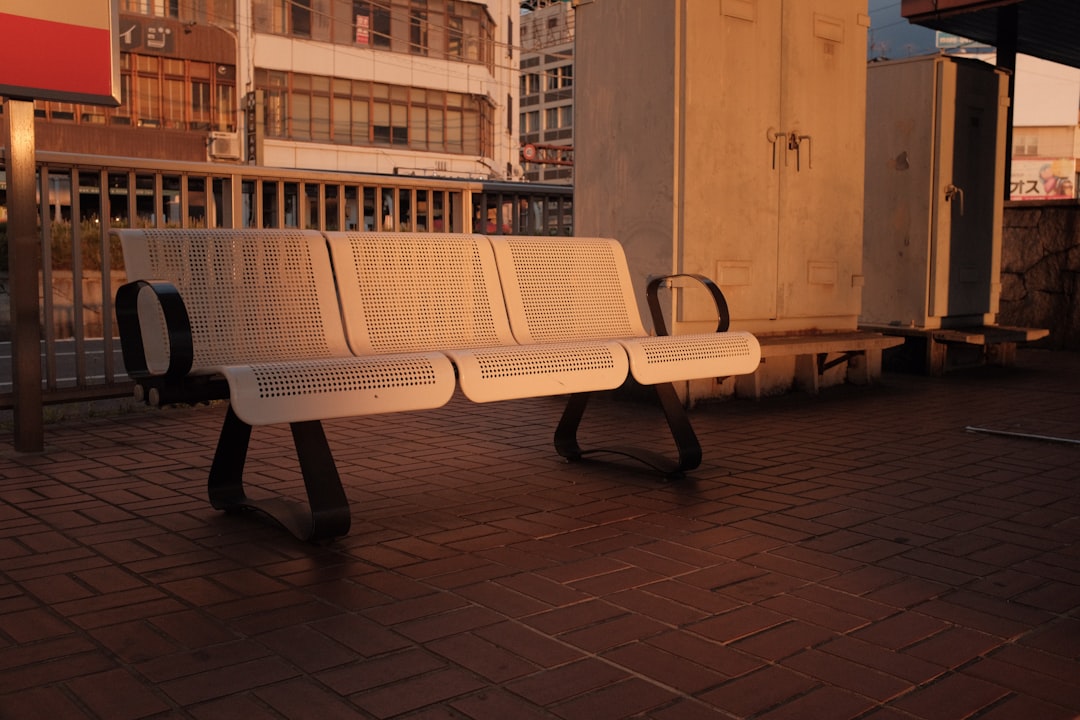 white and black bench on gray concrete floor