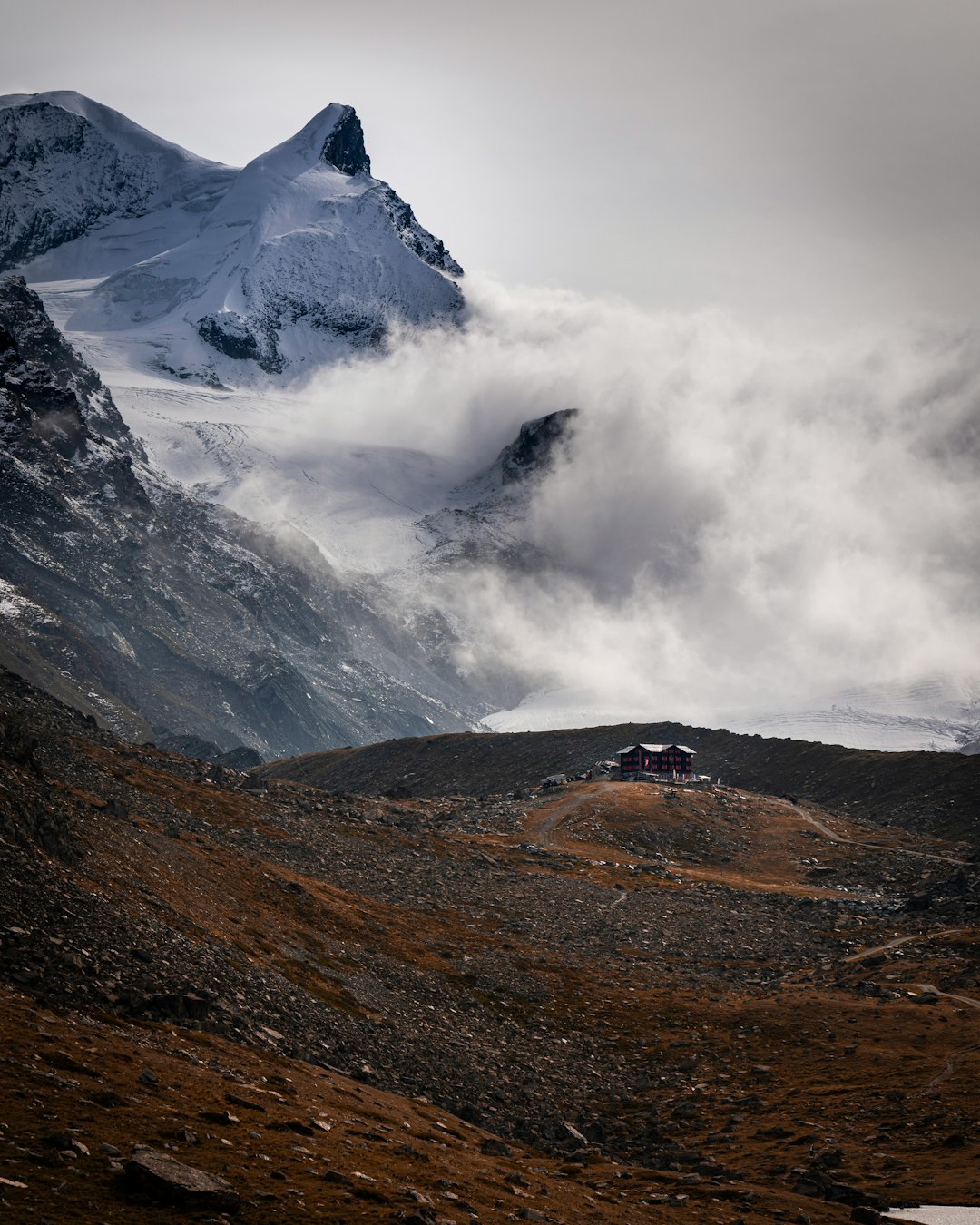 snow covered mountain under cloudy sky during daytime