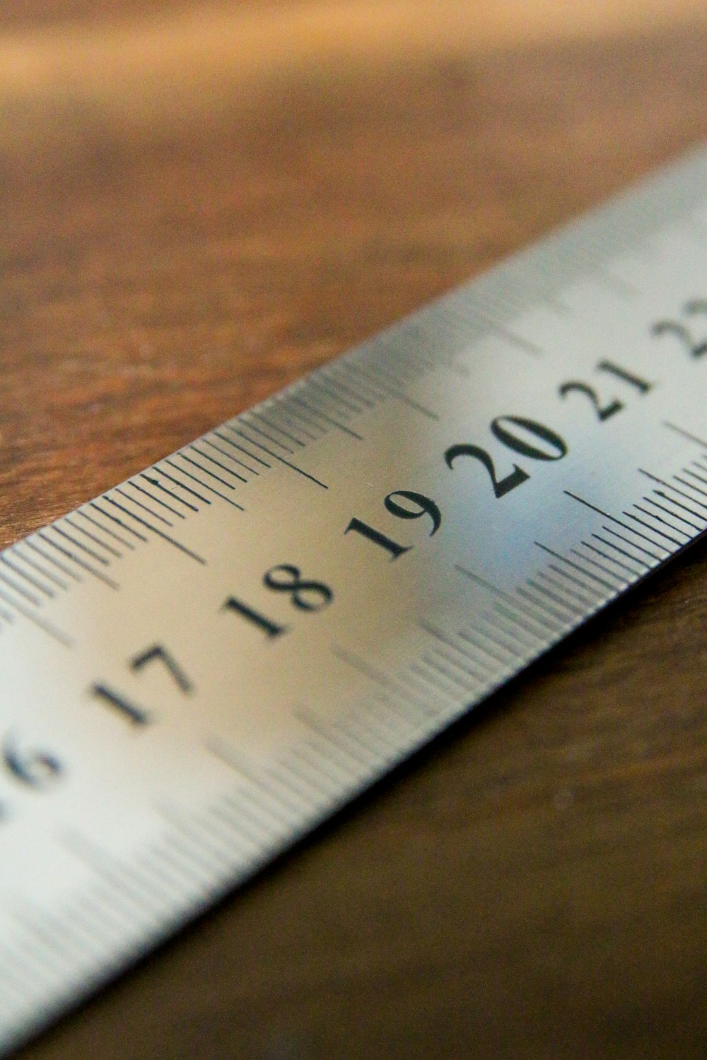 white ruler on brown wooden table