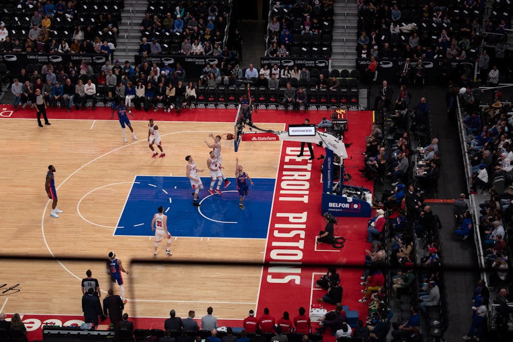 people playing basketball on court