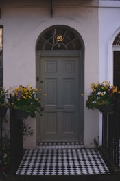 black wooden door with yellow flowers