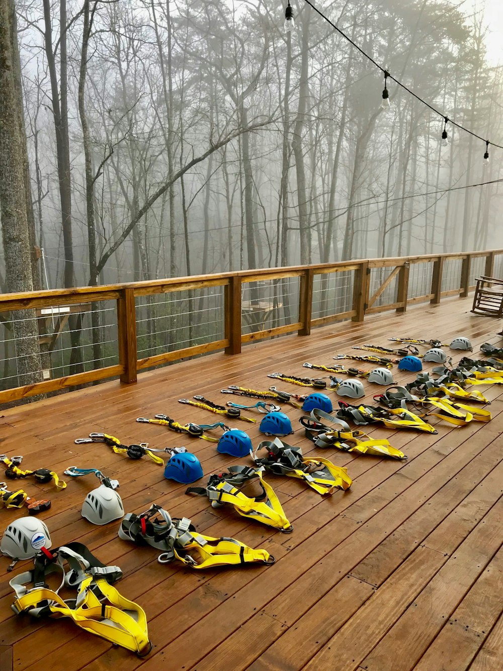 people riding yellow and blue motorcycle on brown wooden bridge during daytime