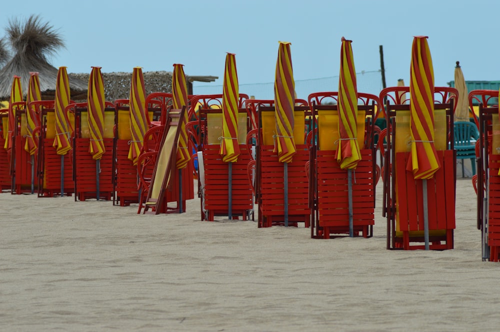 red and yellow folding umbrella on beach during daytime