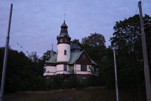 Dark green toned historical magazine cover with classic serif lettering and an illustration of a local landmark.