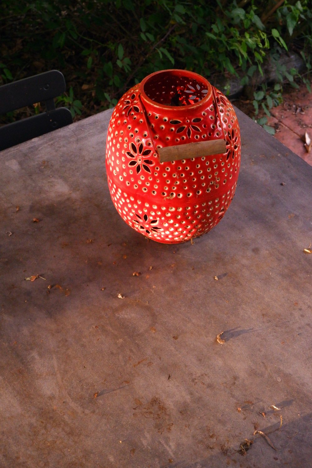 red and white ceramic vase on brown wooden table