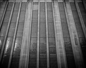 An expansive commercial building featuring large glass windows and sturdy structural design.