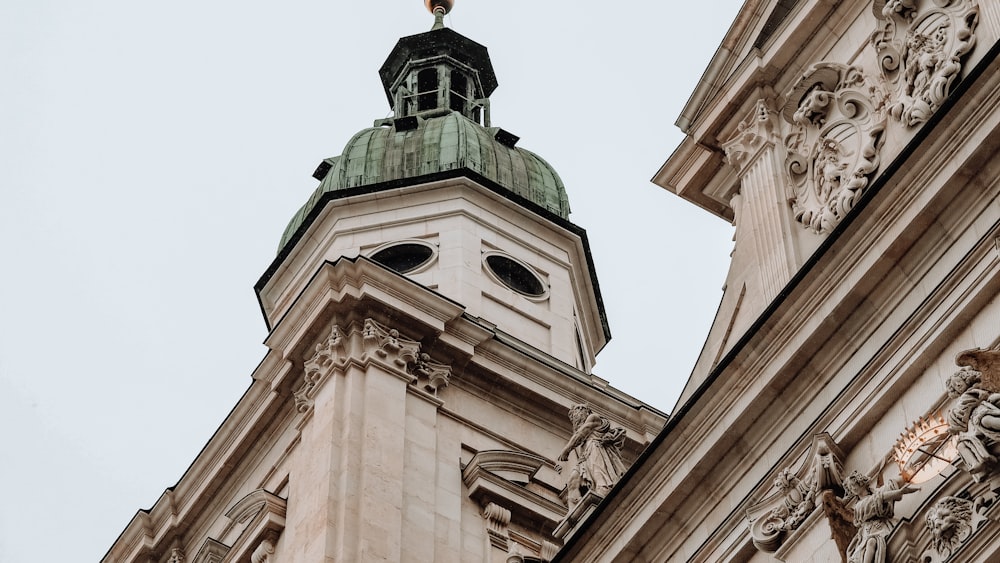 a large tall tower with a clock on the side of a building