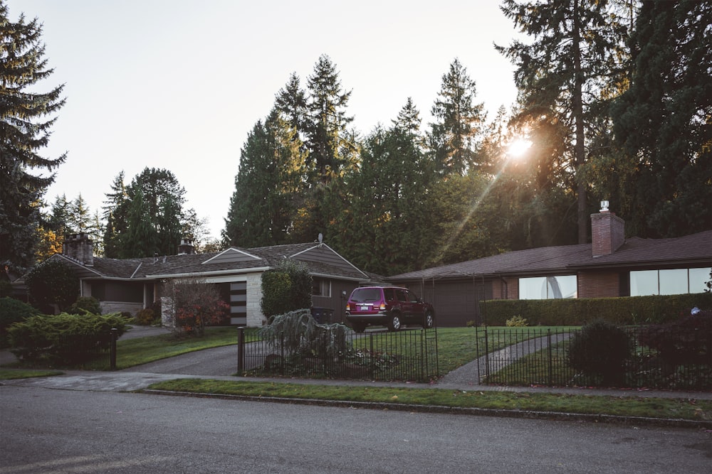 white and brown house near green trees during daytime