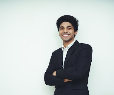 man in black suit jacket smiling