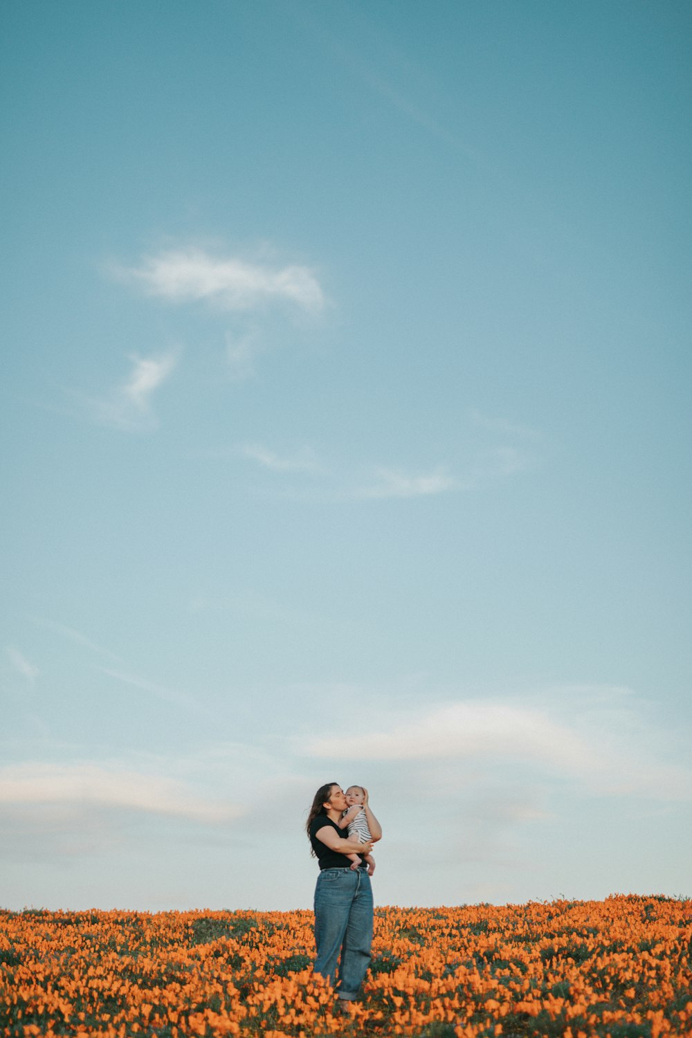 woman in black and white floral dress standing under blue sky during daytime