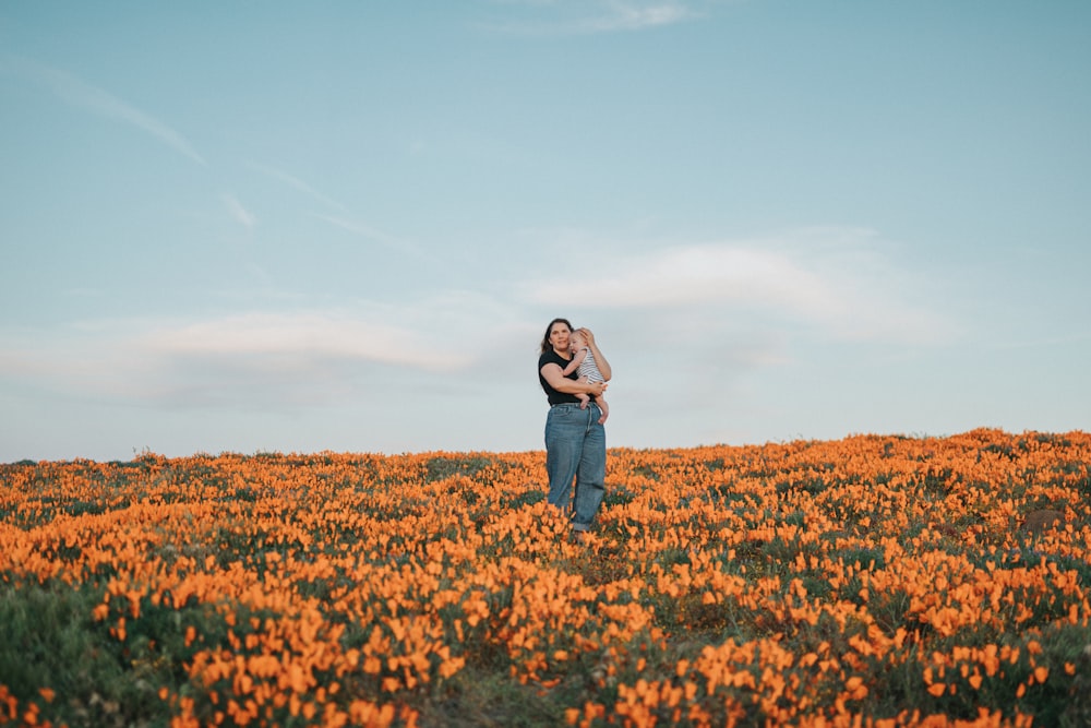 woman in black jacket standing on brown grass field during daytime