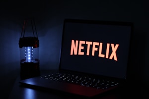 black laptop computer on black table