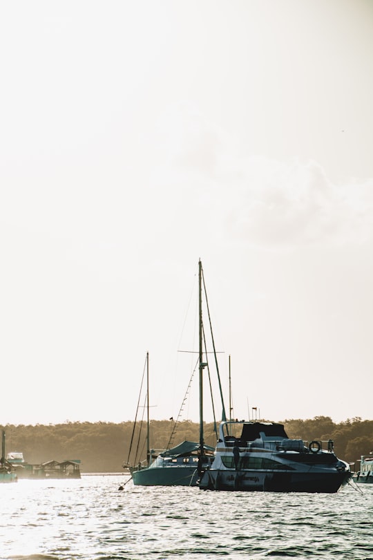 white sail boat on sea during daytime in Sanur Indonesia