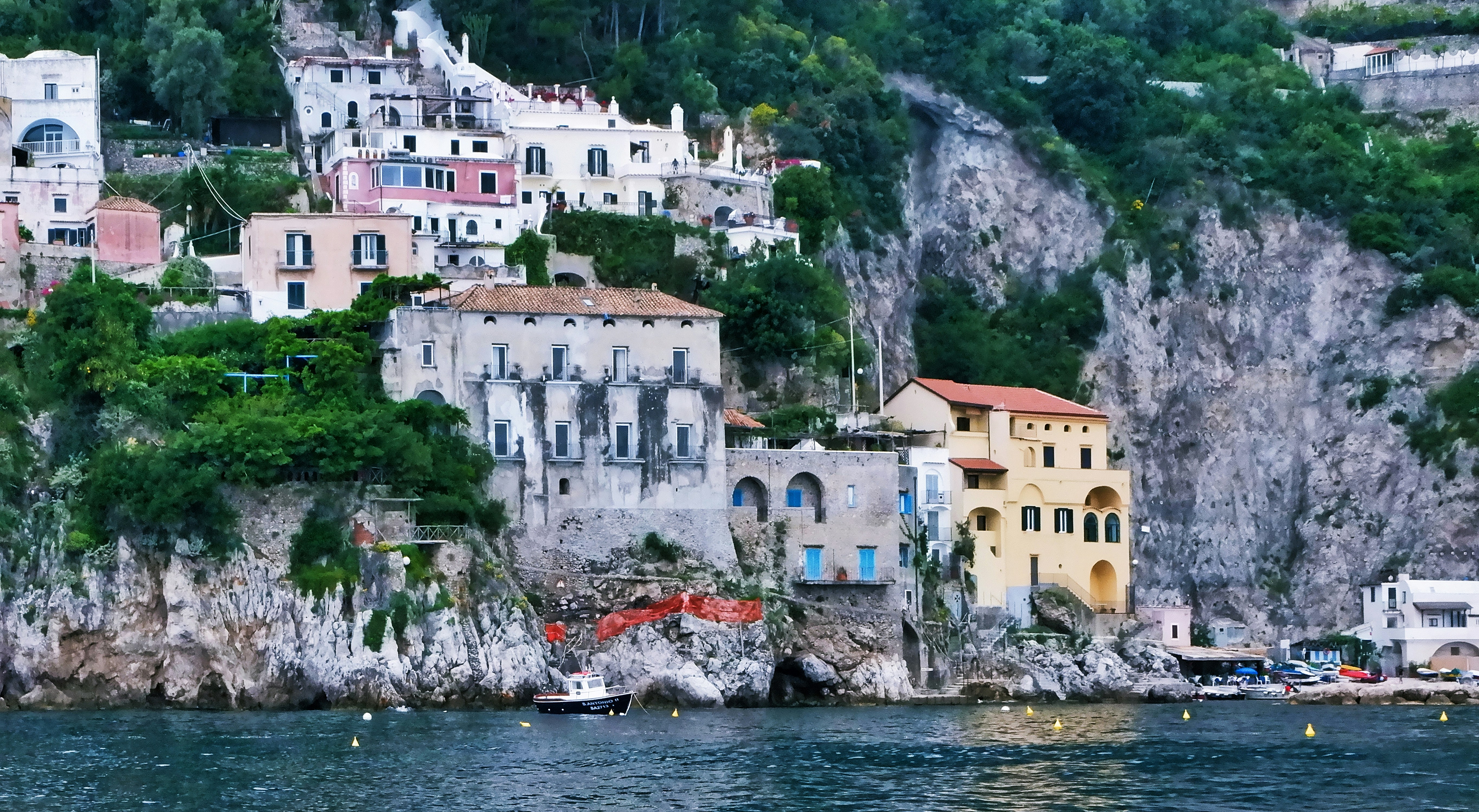 white and brown concrete houses near body of water during daytime amalfi coast zoom background