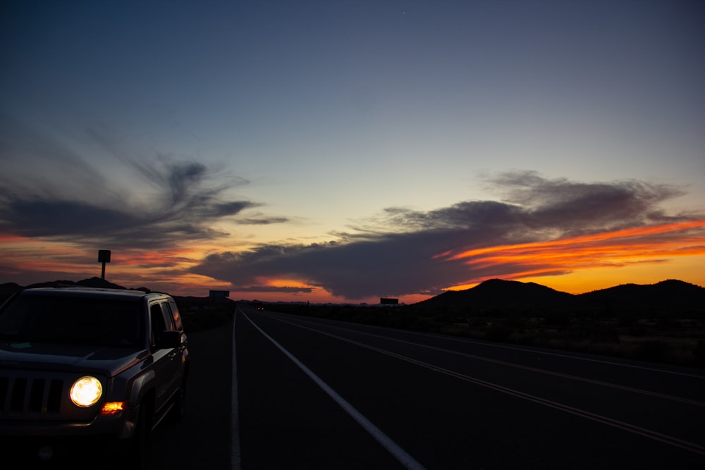 white car on road during sunset