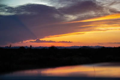 Sunset over Pahrump desert mountains with a small business storefront in the foreground.