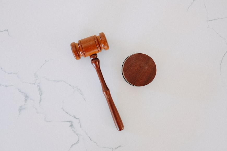 a wooden gavel on a marble countertop