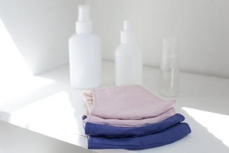 A neat stack of gloves and mop heads ready for cleaning tasks, with a soft natural light.