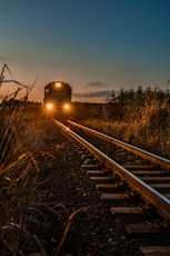 train on rail during sunset
