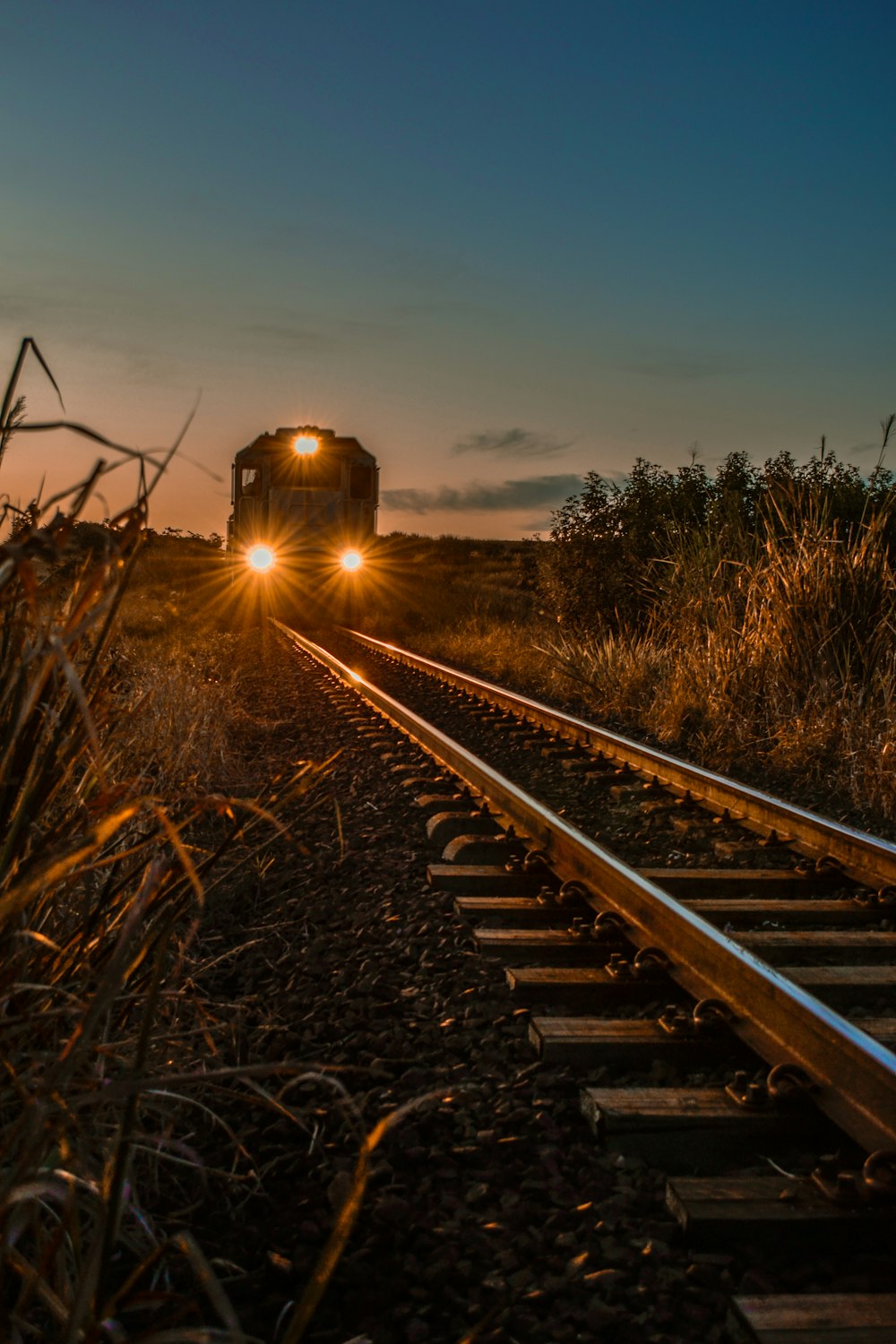 train on rail during sunset