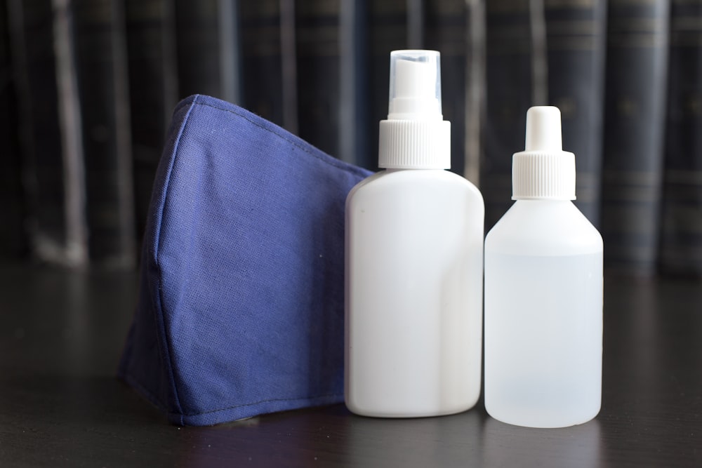 white plastic bottle on blue textile